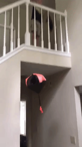 A reviewer’s video demonstrating the red parachute toy being dropped from the top of a staircase