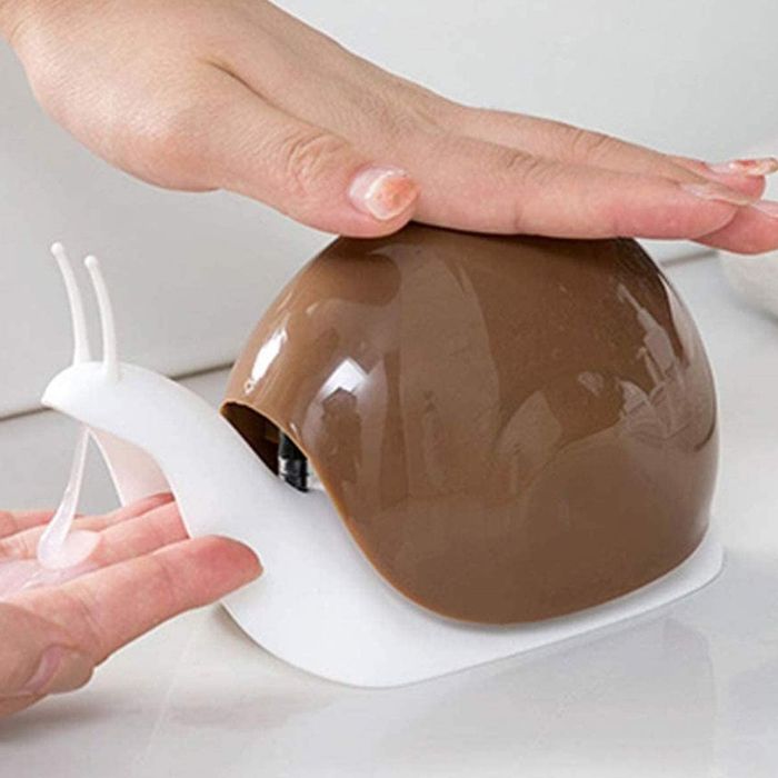 a person dispensing soap from a snail-shaped soap dispenser