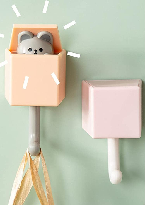 a product photo of one of the animal hooks, demonstrating how the head pops up when weight is applied