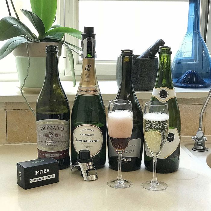 The bottle sealer placed next to a selection of champagne bottles.