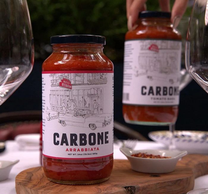 Two jars of the arrabbiata pasta sauce sitting on a table