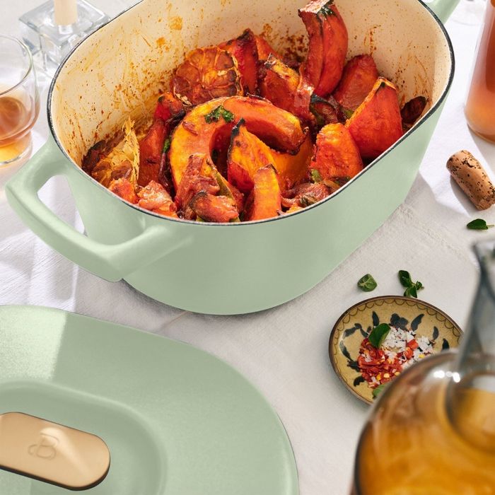 A mint-colored Dutch oven filled with squash, showcasing its stylish design and versatility.