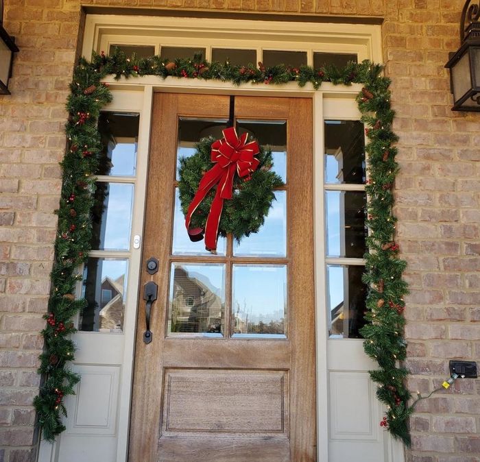Reviewer photo showing the garland beautifully framing the outside of their front door