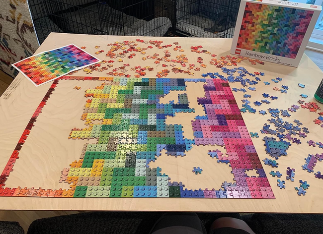 A partially completed jigsaw puzzle with a rainbow gradient, titled.