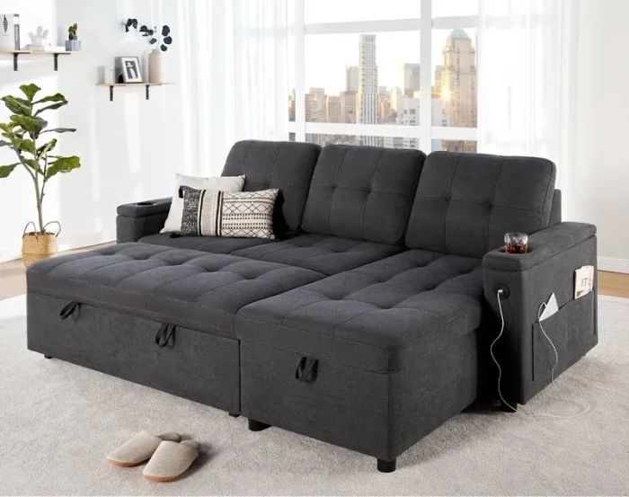 A modern sectional sofa featuring built-in storage and cup holders, perfectly placed in a bright living room with a scenic city view, slippers, and stylish throw pillows completing the setting.