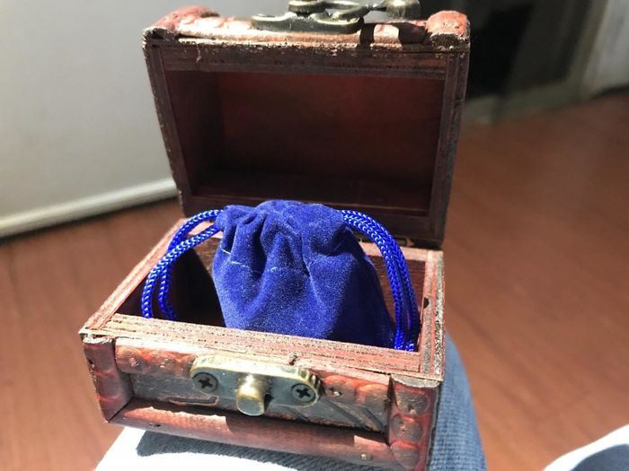 decorative treasure chest containing a small pouch inside