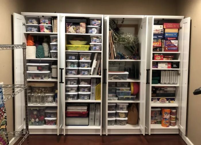 those same closets open to reveal ample storage capacity, with 20 shelves in total, each one adjusted to fit its contents perfectly.