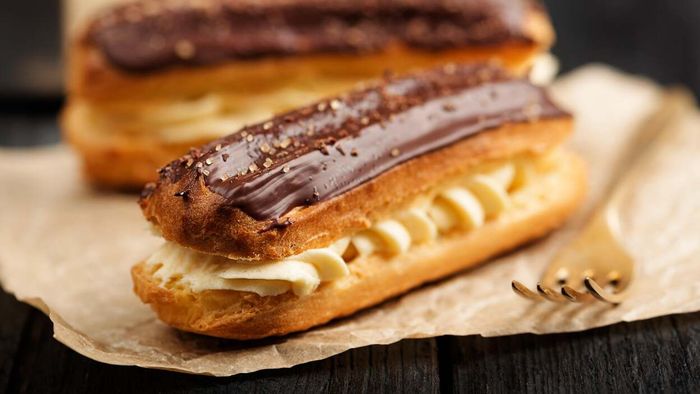 A pair of èclairs elegantly placed on a table.