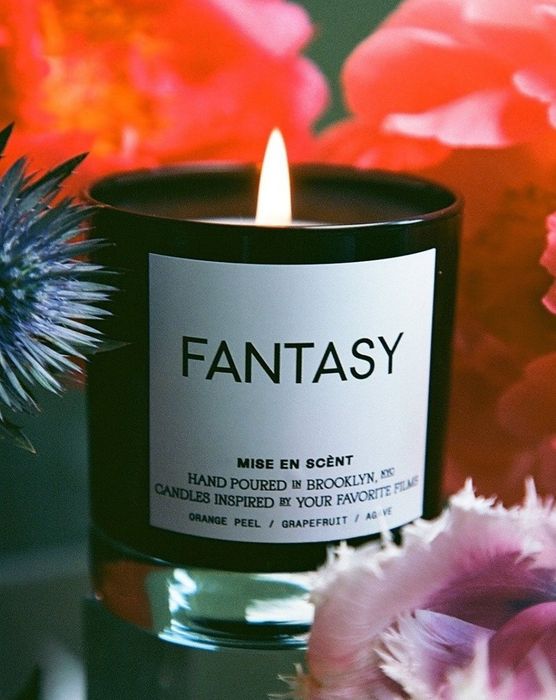 a lit black glass candle