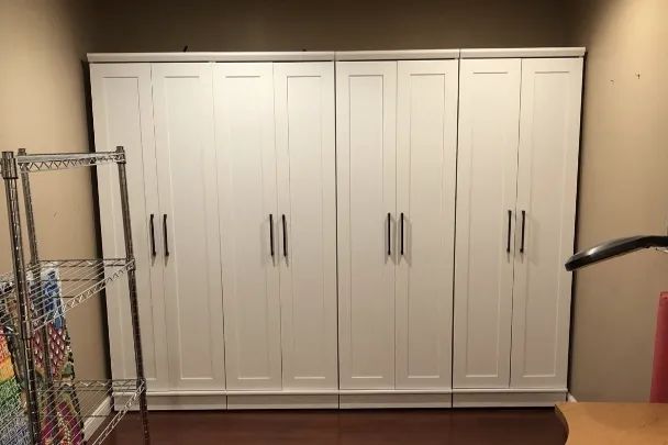 a reviewer’s image of four storage closets arranged together to create a built-in appearance