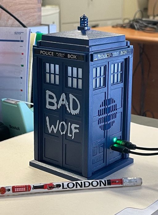 A reviewer’s photo of the TARDIS Bluetooth speaker, capturing its sleek design and glowing blue details.