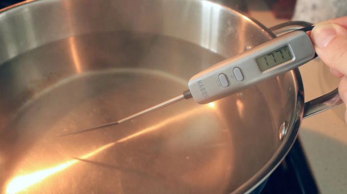 A thermometer reading 177°F in a pot of water.