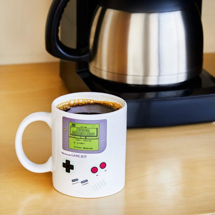 Lifestyle photo of a Gameboy mug filled with coffee