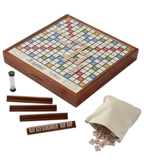 product image of a wooden Scrabble board with pieces and a storage bag