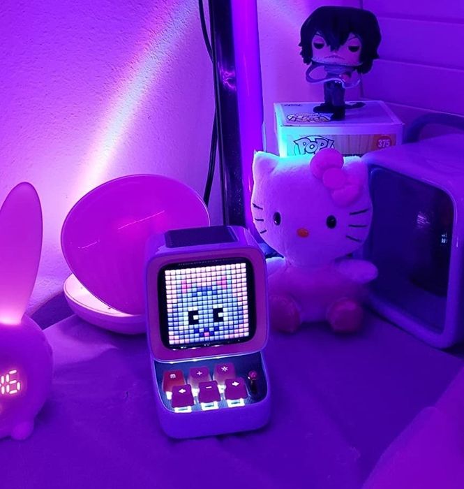 A reviewer’s photo showcasing the Divoom Bluetooth speaker glowing in the dark.