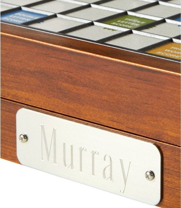 close-up of an engraved personal name on the Scrabble board