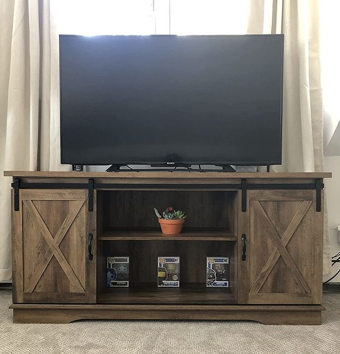 A reviewer's photo showing the TV stand with a television placed on top.