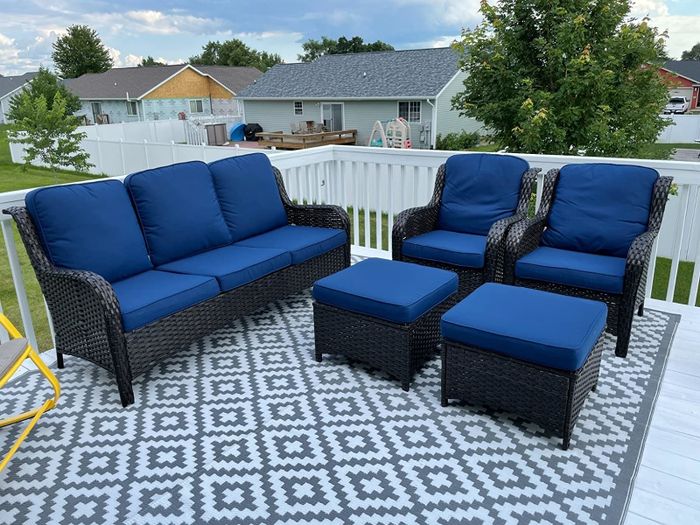 A reviewer’s photo of the five-piece patio set featuring blue cushions