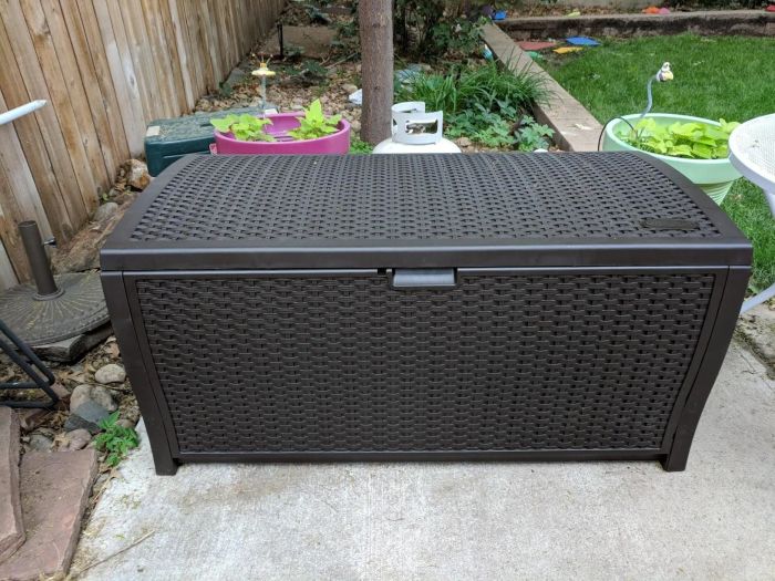 the brown wicker storage bench