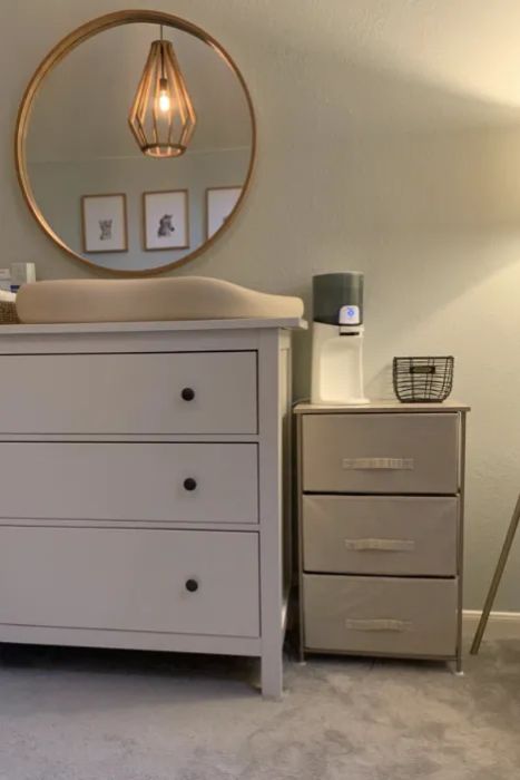 a reviewer’s shelf beside the baby changing station on top of a dresser