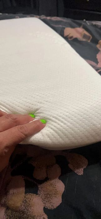 Reviewer image of the pillow, showcasing its thin profile.