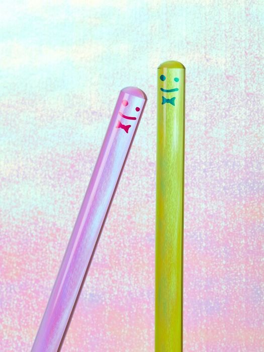 The top of a plunger handle with a cheerful smiley face design