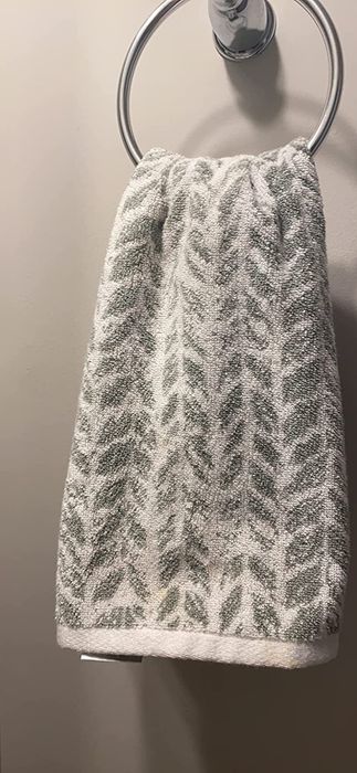 Reviewer image of a gray and white product displayed on a towel rack