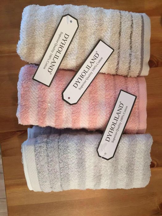 Reviewer image of gray, pink, and tan striped towels neatly folded together on a table
