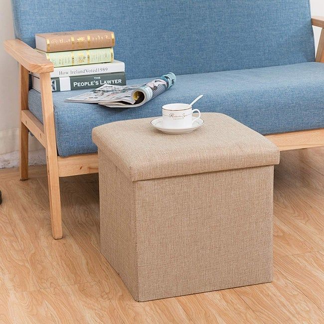 The beige ottoman with memory foam top sitting comfortably in a living room