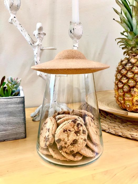 A cookie in a jar placed on the counter