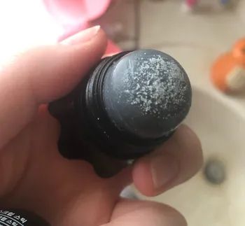 The cap is removed to reveal the salt on top of the remover.