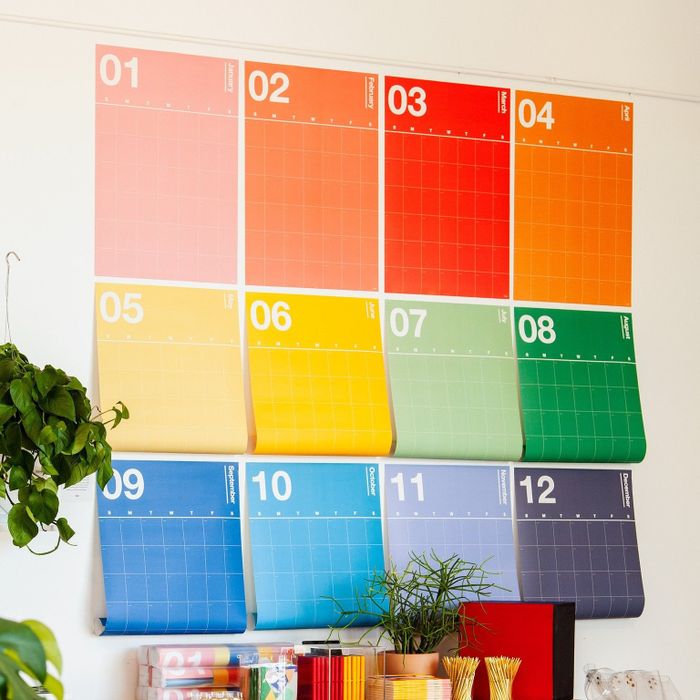 Colorful, monthly calendars displayed on a wall, adding vibrancy to any room