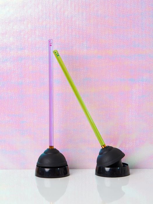Plungers with neon-colored handles and a sleek black base