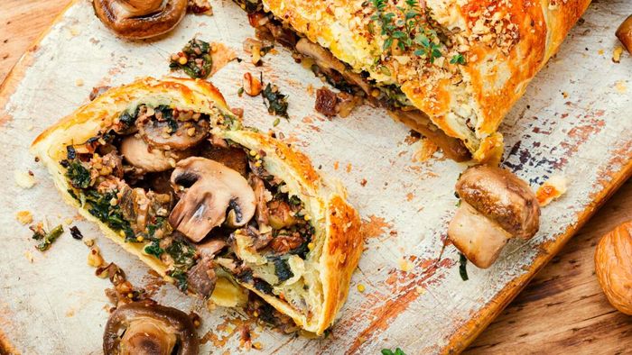A slice of vegan Wellington elegantly presented on a plate.