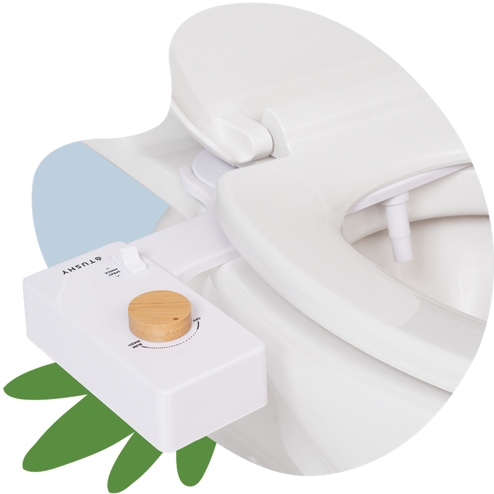A white bidet with a wooden knob installed on a toilet under the seat
