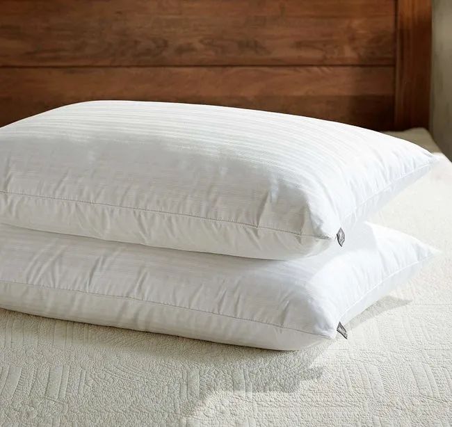 A product image showing two pillows stacked on top of each other, crafted from standard white material with subtle light stripes.