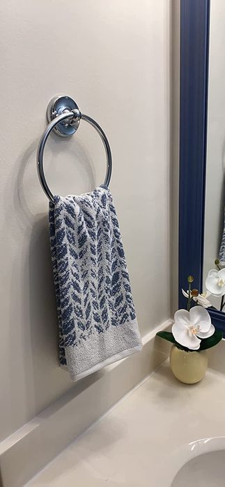 Reviewer image of a blue and white leaf-patterned hand towel hanging on a towel rack