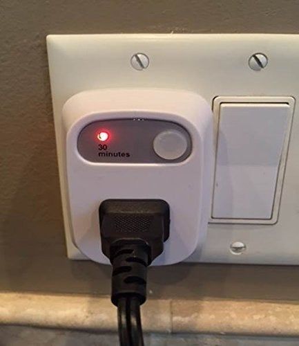 Close-up of the timer plug in an outlet.
