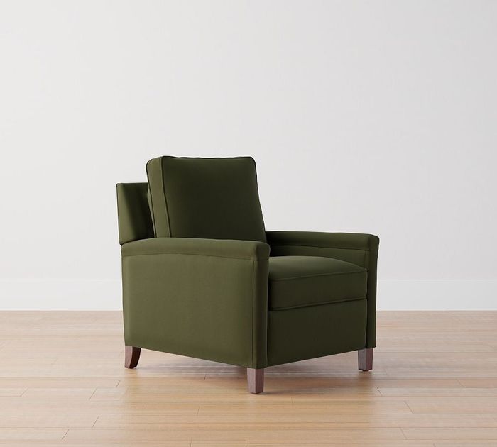 A dark green velvet recliner with square arms.