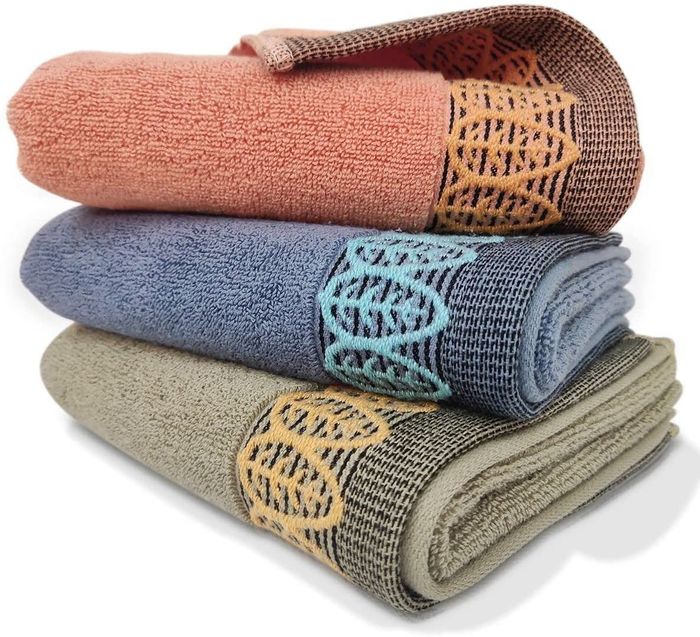 Red, blue, and green hand towels with embroidered leaves adorning the bottom edges