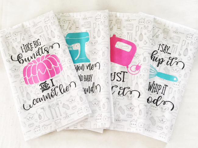 Four black and white hand towels featuring humorous quotes and kitchen appliance illustrations