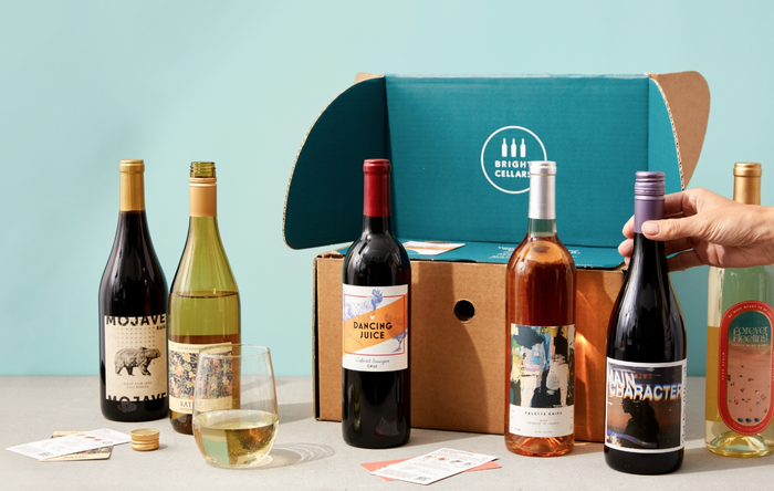 six bottles of wine arranged in front of a box