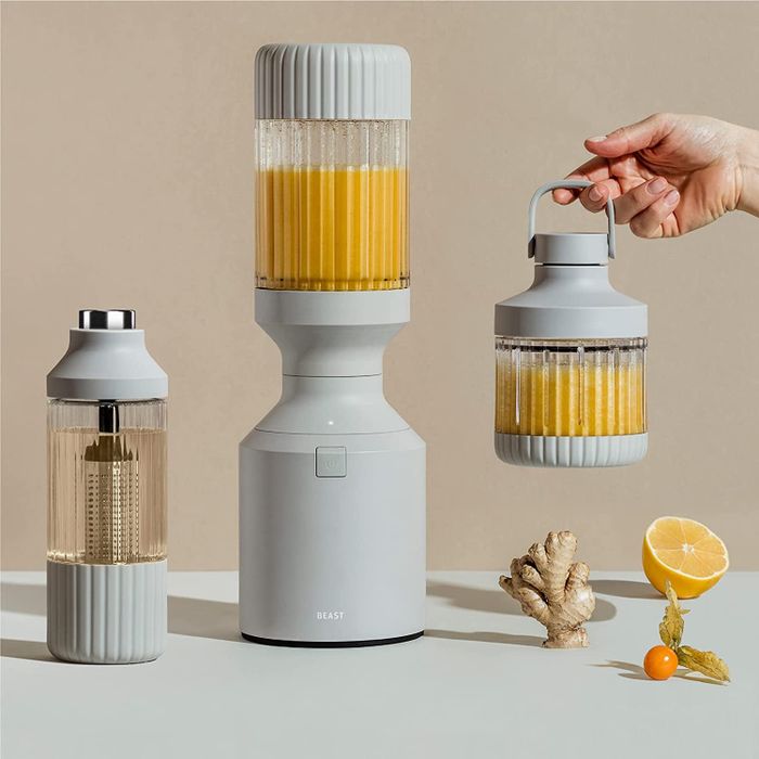 The grey Beast blender with an infusion cup and a smaller cup with a handle lid.