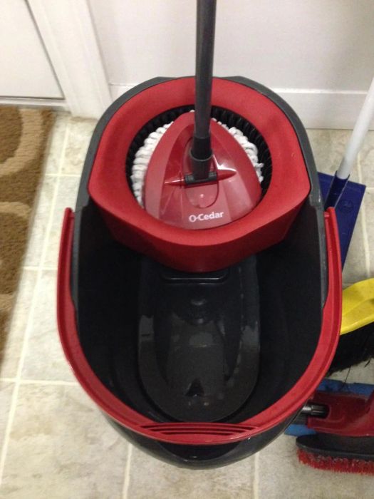 A spin mop placed in a bathroom setting