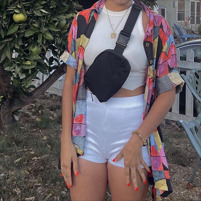 a customer sporting a black belt bag slung across their chest