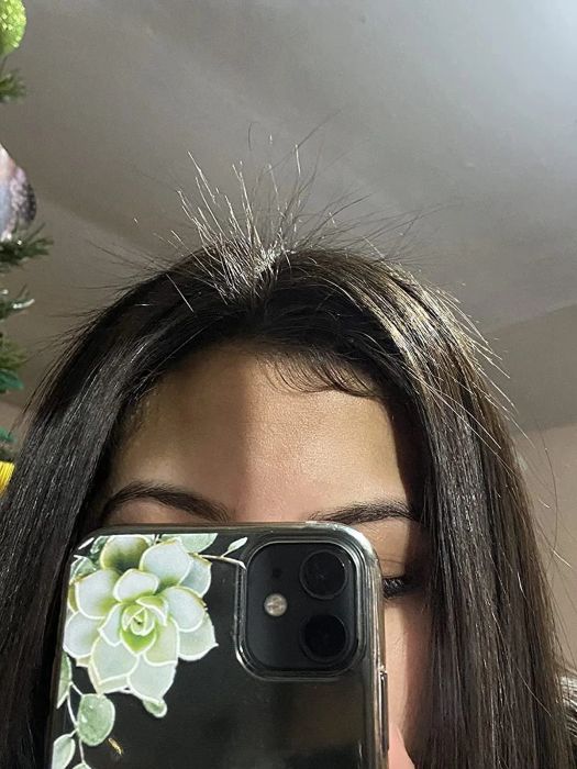 A before photo of a reviewer with frizzy, stray flyaways in their hair