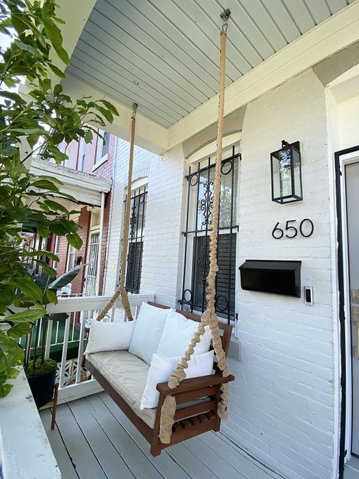 The swing is pictured on a reviewer's porch