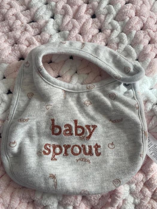 Gray baby bib featuring