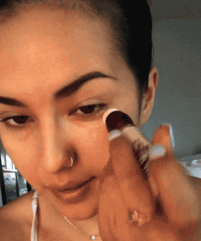 A gif showing the same Mytourer applying the concealer under their eyes