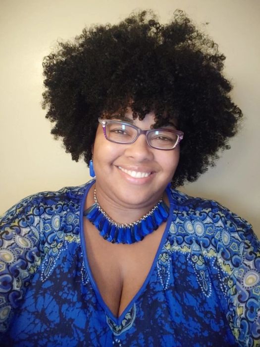 A photo of a reviewer showcasing their curly hair.